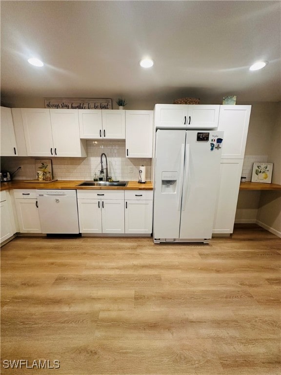 kitchen featuring white cabinetry, white appliances, and light wood-type flooring