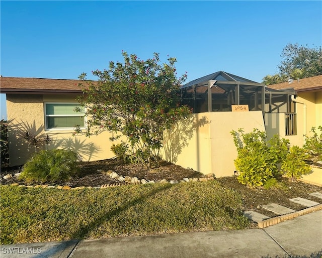 view of property exterior with a lanai