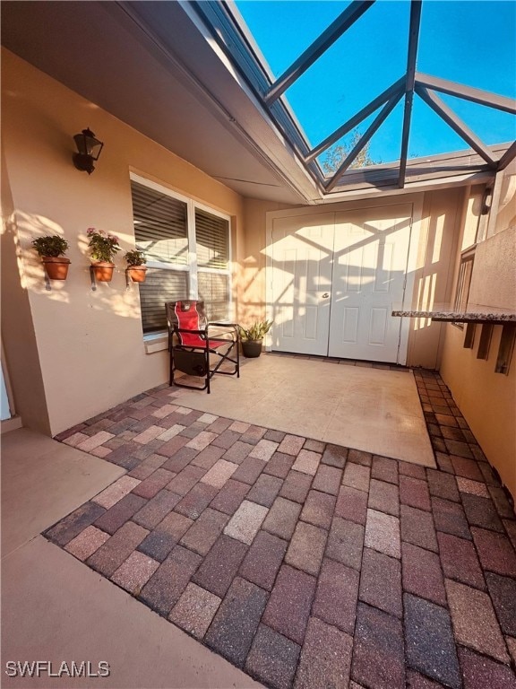 view of patio with glass enclosure