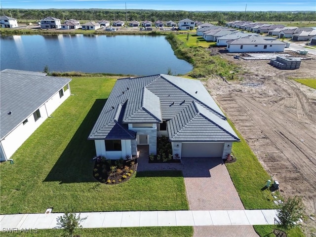 birds eye view of property with a water view