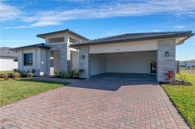 view of front of property with a front yard and a garage