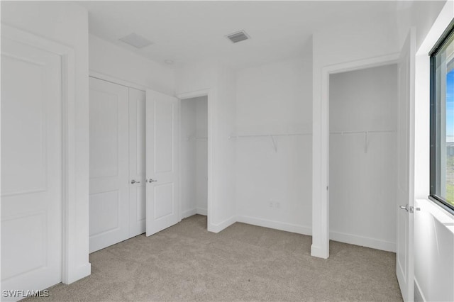 unfurnished bedroom with light carpet