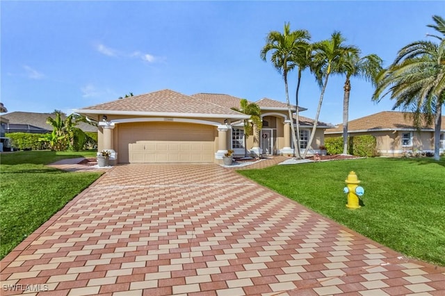 view of front of house featuring a garage and a front lawn