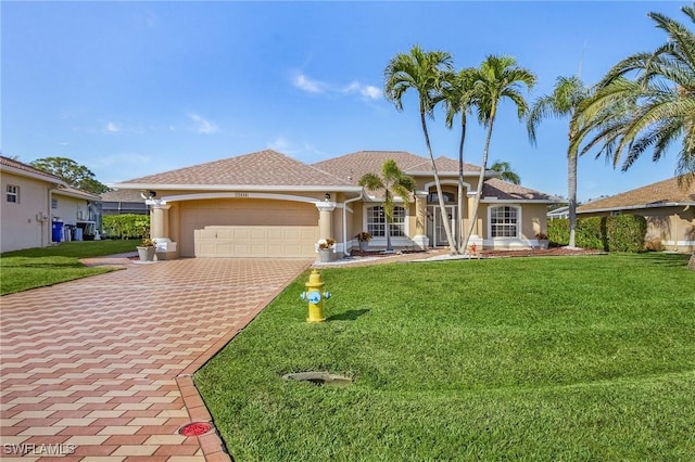 ranch-style home with a garage and a front lawn