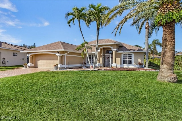 mediterranean / spanish home with a garage and a front yard