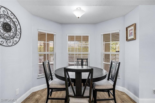 dining area with hardwood / wood-style floors