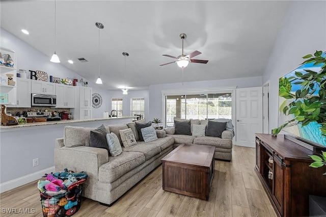 living room featuring ceiling fan, high vaulted ceiling, and light hardwood / wood-style floors