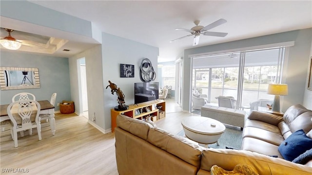 living room featuring ceiling fan and light hardwood / wood-style flooring