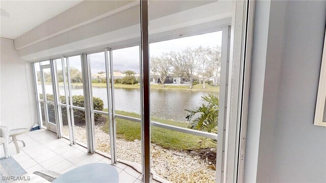 entryway featuring light tile patterned flooring and a water view