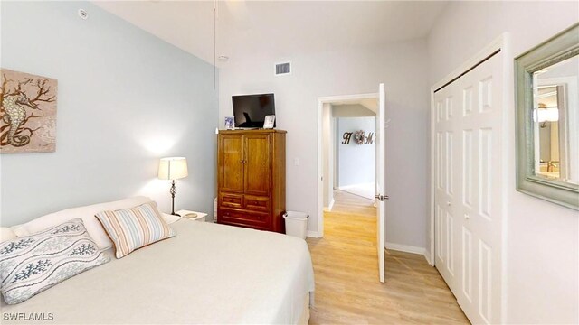 bedroom with light wood-type flooring and a closet