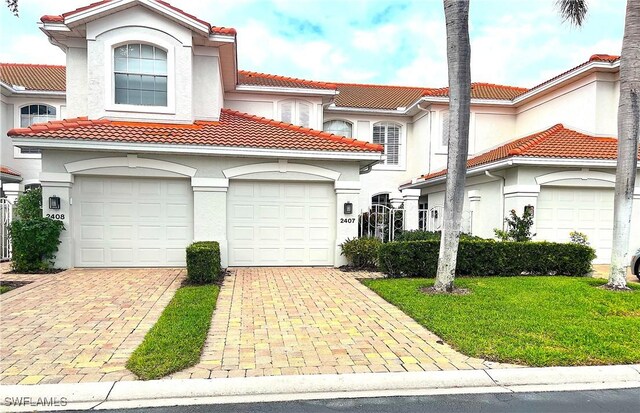 mediterranean / spanish-style house with a front yard and a garage