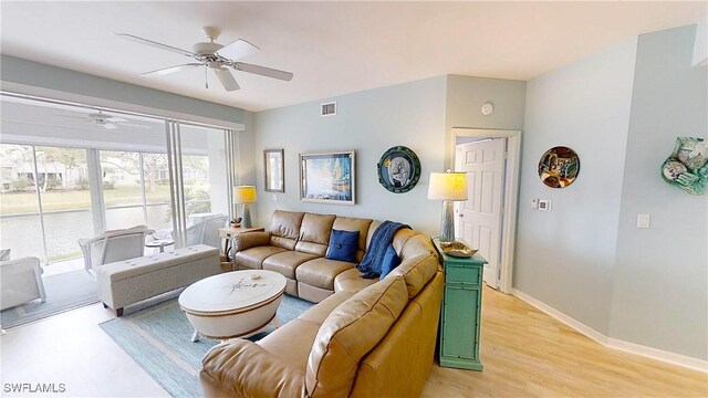 living room featuring ceiling fan and light wood-type flooring