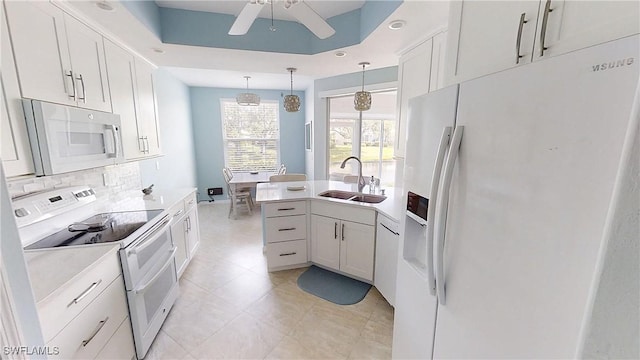 2135 Arielle Dr Unit 2407, Naples, FL 34109 - kitchen featuring white appliances, decorative backsplash, ceiling fan, light countertops, and hanging light fixtures