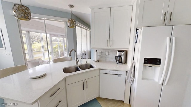 2135 Arielle Dr Unit 2407, Naples, FL 34109 - kitchen featuring white appliances, light countertops, pendant lighting, white cabinets, and a peninsula