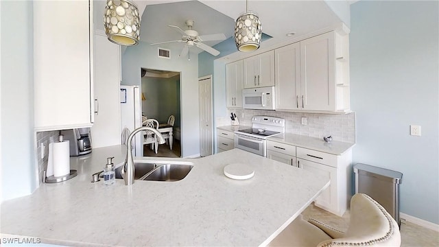 2135 Arielle Dr Unit 2407, Naples, FL 34109 - kitchen featuring white appliances, a peninsula, backsplash, a ceiling fan, and white cabinetry