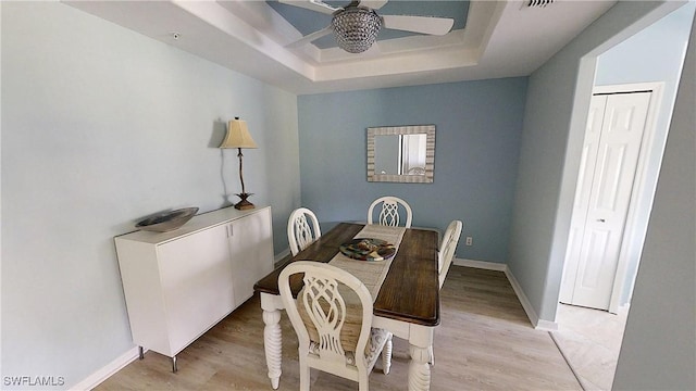 2135 Arielle Dr Unit 2407, Naples, FL 34109 - dining area featuring a ceiling fan, a raised ceiling, and light wood-style floors