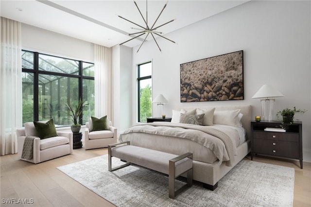 bedroom featuring light hardwood / wood-style floors and a notable chandelier