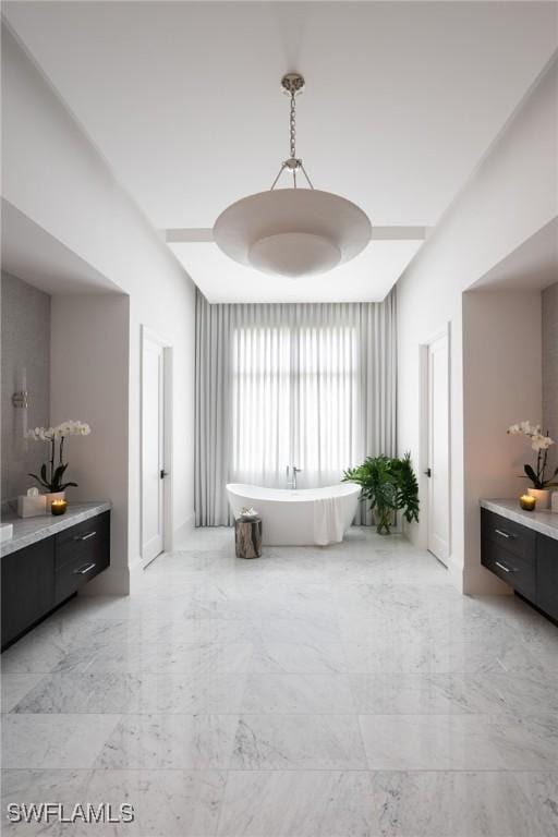 bathroom with vanity and a tub