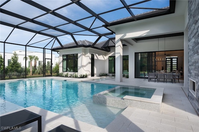 view of pool with a lanai, an in ground hot tub, and a patio