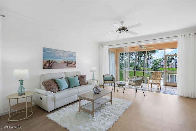 living room featuring ceiling fan and light wood-type flooring