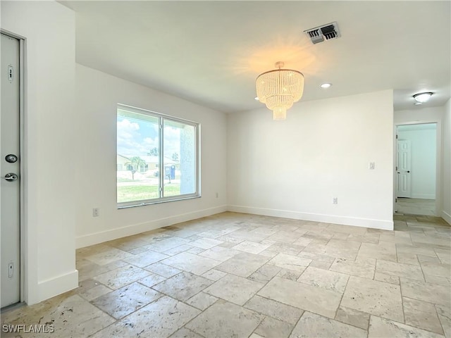 unfurnished room with an inviting chandelier