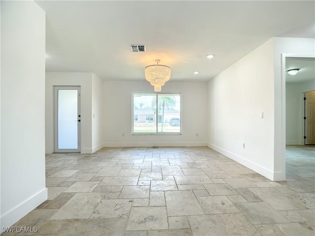 unfurnished room with an inviting chandelier