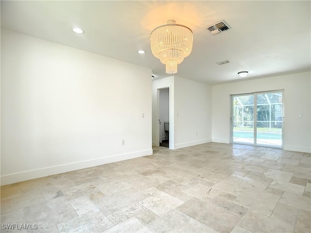 unfurnished room with a notable chandelier