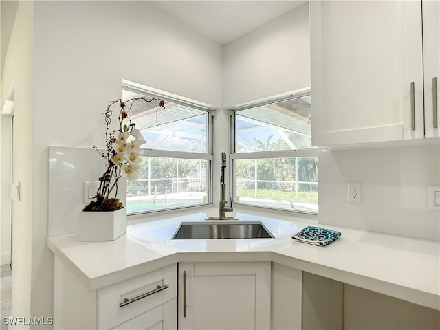 kitchen featuring white cabinets and sink