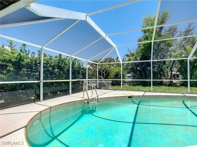 view of swimming pool with a lanai and a patio area