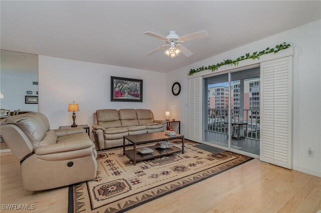 living room featuring light hardwood / wood-style floors and ceiling fan