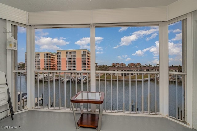 sunroom / solarium with a water view and plenty of natural light