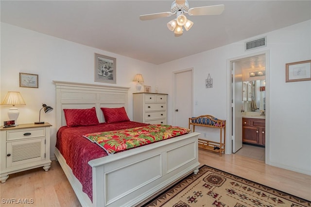 bedroom with ceiling fan, ensuite bathroom, and light hardwood / wood-style floors