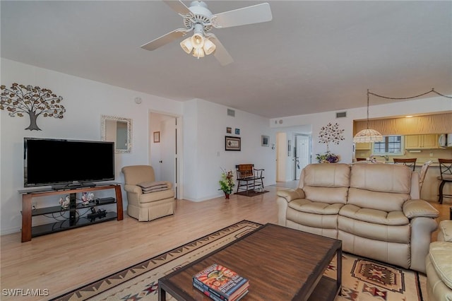 living room featuring ceiling fan and wood-type flooring