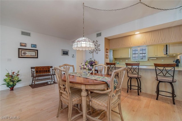 dining space featuring light hardwood / wood-style floors