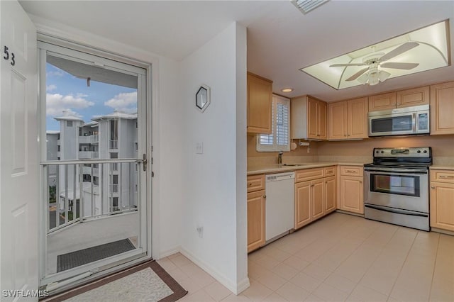 kitchen with ceiling fan, appliances with stainless steel finishes, sink, and light brown cabinets