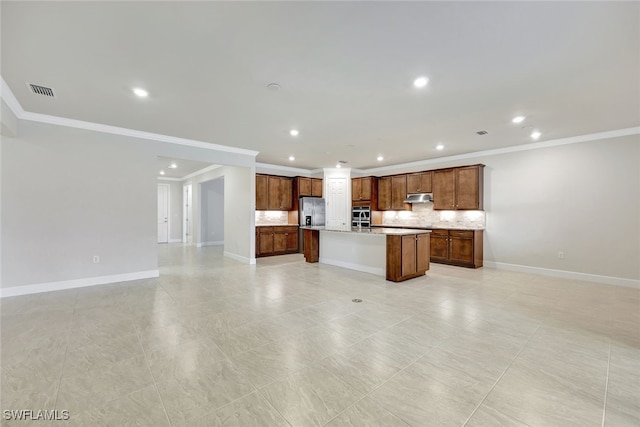 kitchen with stainless steel refrigerator with ice dispenser, decorative backsplash, a kitchen island with sink, and crown molding