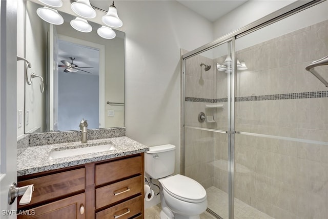 bathroom with ceiling fan, an enclosed shower, vanity, and toilet