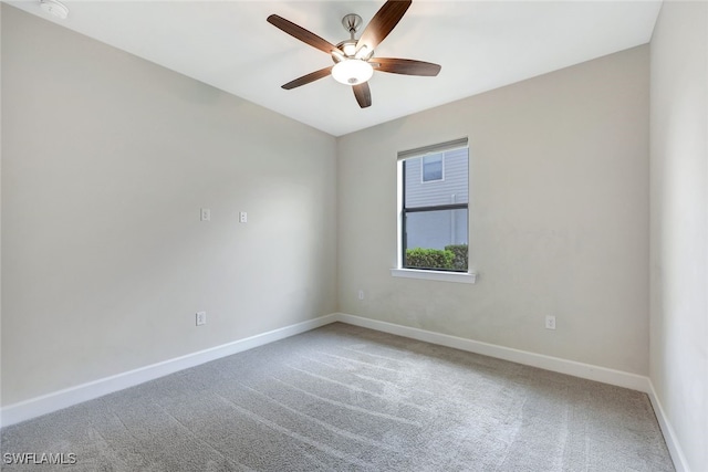 carpeted spare room with ceiling fan