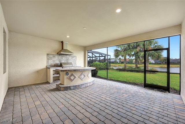 unfurnished sunroom featuring a water view