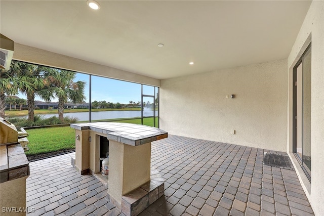 unfurnished sunroom with a water view