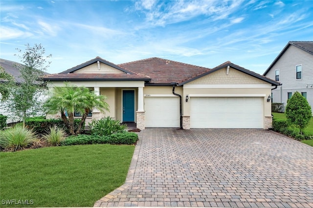 view of front of property with a front yard and a garage