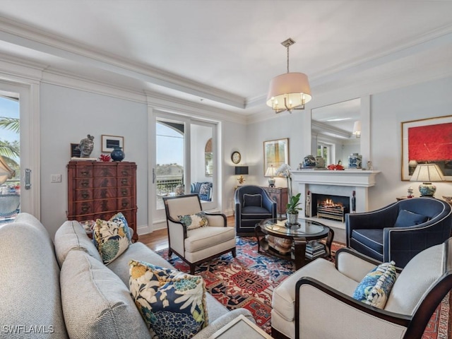 living room featuring hardwood / wood-style floors, plenty of natural light, and crown molding