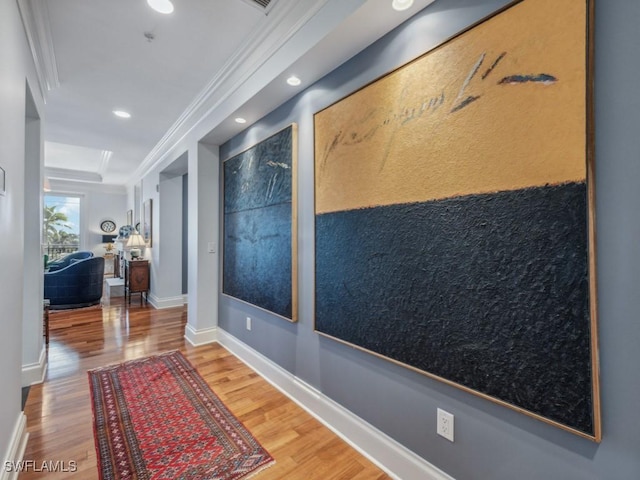 hallway featuring hardwood / wood-style flooring and crown molding