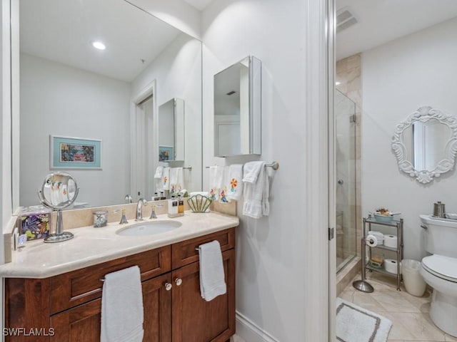 bathroom featuring tile patterned flooring, vanity, toilet, and a shower with door