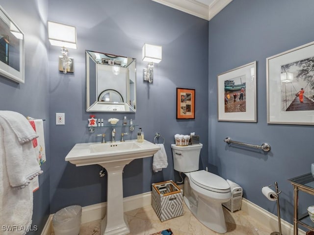 bathroom featuring toilet and crown molding