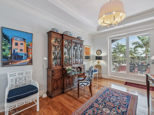 home office with a chandelier, hardwood / wood-style floors, and ornamental molding