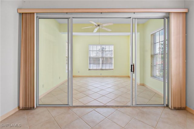 entryway with light tile patterned flooring, ceiling fan, and a wealth of natural light