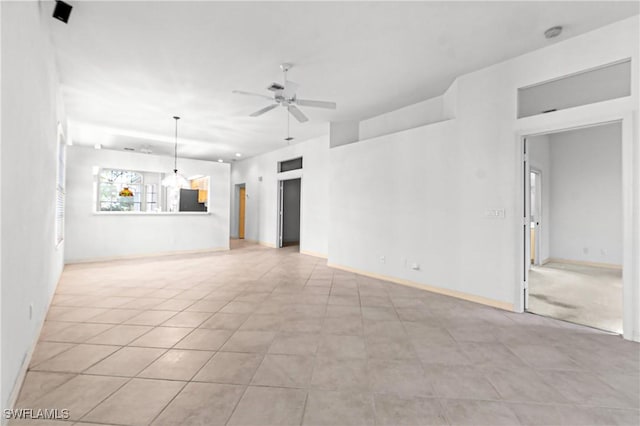 unfurnished living room featuring ceiling fan and light tile patterned flooring