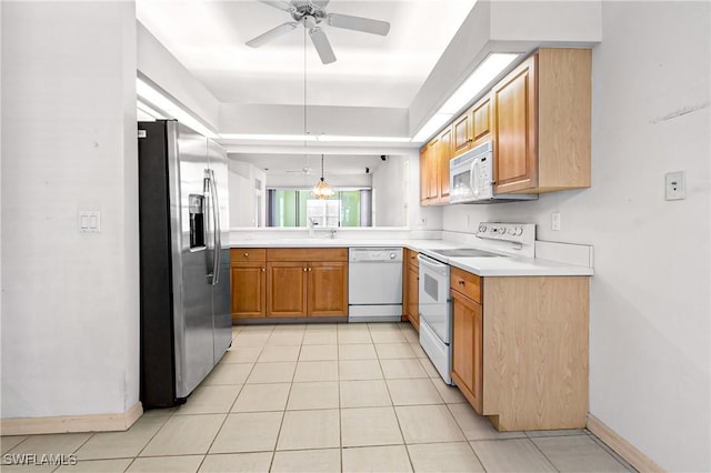 kitchen with light tile patterned floors, ceiling fan, white appliances, pendant lighting, and sink