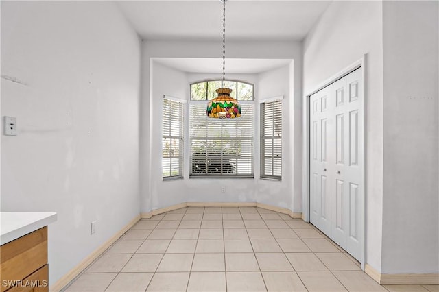 unfurnished dining area featuring light tile patterned floors